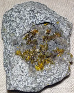Uranophane-β in leucogranite (Rössing Uranium Mine, Erongo, Namibia).jpg