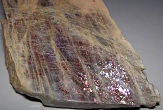 Anorthoclase feldspar with iridescent hematite inclusions (Potanikha Quarry, Kasli, Ural Mountains, Russia) 2 (30105516385).jpg