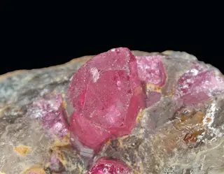 Crystals of liddicoatite and quartz.jpg